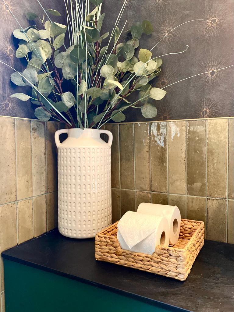 Simple storage solutions in the form of a basket for toilet paper
